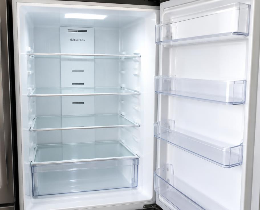 Clean, empty fridge with glass shelves and door compartments